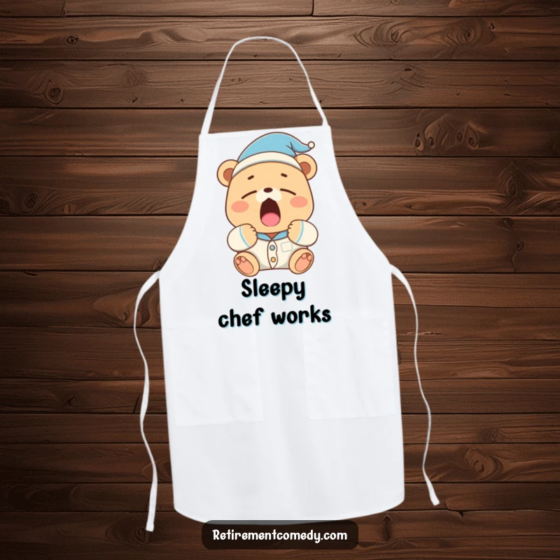 Funny sleepy bear wearing pajamas and a nightcap yawns widely on this apron, making it a humorous kitchen accessory.