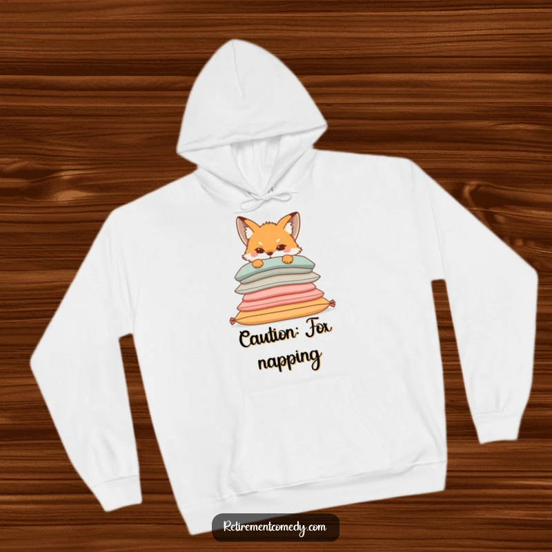 Funny hoodie with a sly fox peeking out from behind a stack of plush, comfortable cushions, perfect for cozy, mischievous moments.